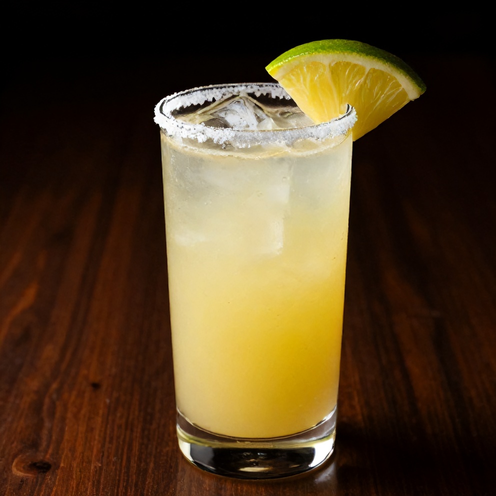 Pineapple Margarita Mocktail served in a glass with a lime wheel and a salted rim