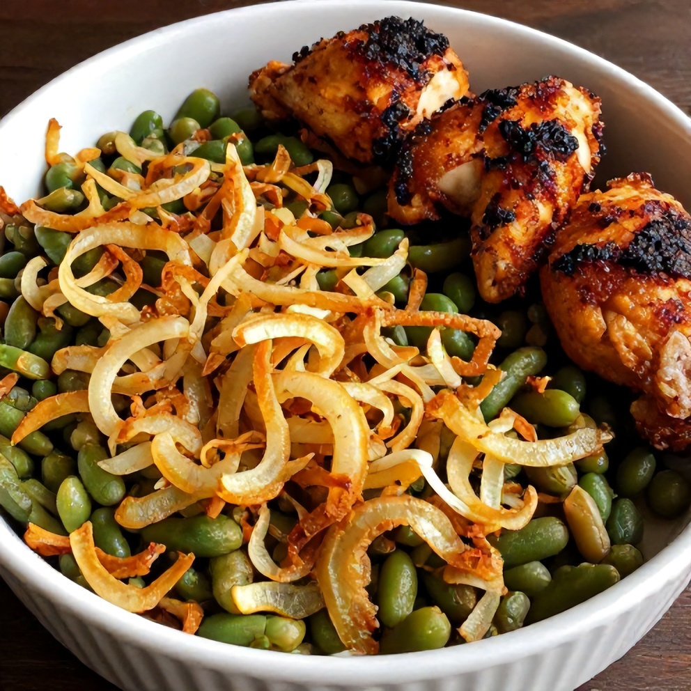 Perfectly baked green bean casserole with crispy onions and a side of chicken thighs